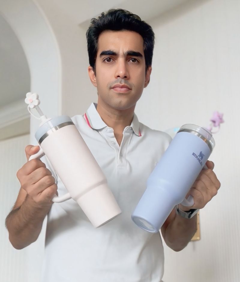 Mohit Sadaani holding two oversized Stanley tumblers for the Stanley and Crocs brand-resurgence note.